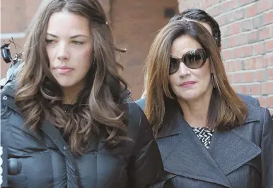  ?? STAFF PHOTO BY ANGELA ROWLINGS ?? EXIT SIGN? Debbie DiMasi, right, wife of jailed former House Speaker Salvatore F. DiMasi, leaves federal court yesterday with her daughter, Ashley, following a hearing to request his early release.