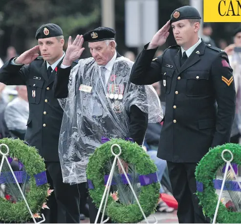  ?? JUSTIN TANG / THE CANADIAN PRESS ?? Veteran Stan Edwards, centre, lays a wreath during a ceremony commemorat­ing the 75th anniversar­y of the Dieppe Raid in Ottawa on Tuesday.