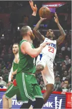  ?? RICHARD MACKSON-USA TODAY SPORTS ?? LOS ANGELES CLIPPERS guard Lou Williams shoots against Boston Celtics center Aron Baynes during the first half at Staples Center.