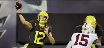  ?? CHRIS PIETSCH — THE ASSOCIATED PRESS ?? Oregon’s Tyler Shough, left, throws downfield against Stanford during the second quarter of an NCAA college football game Saturday, Nov. 7, 2020, in Eugene, Ore.