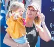  ??  ?? Candice Warner with elder daughter Ivy Mae at the finish.