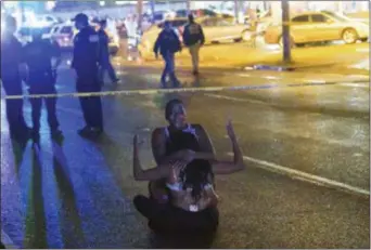  ?? MATTHEW HINTON /THE ADVOCATE VIA AP ?? People react at the scene of a shooting in New Orleans, Saturday, July 28, 2018.