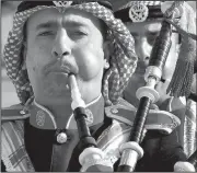  ?? AP/JOHN MacDOUGALL ?? Bagpipe players, part of a Jordanian military band, rehearse before a ceremony handing over German equipment to Jordan on Sunday at Marka airport in Amman, Jordan.