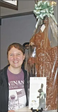  ??  ?? Amy Ambrose shows off the giant chocolate bunny offered as a raffle prize in a fund-raising event being sponsored by Winan's.