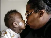  ?? BUTCH DILL — THE ASSOCIATED PRESS ?? Curtis Means kisses his mother, Michelle Butler, at their home in Eutaw, Ala.