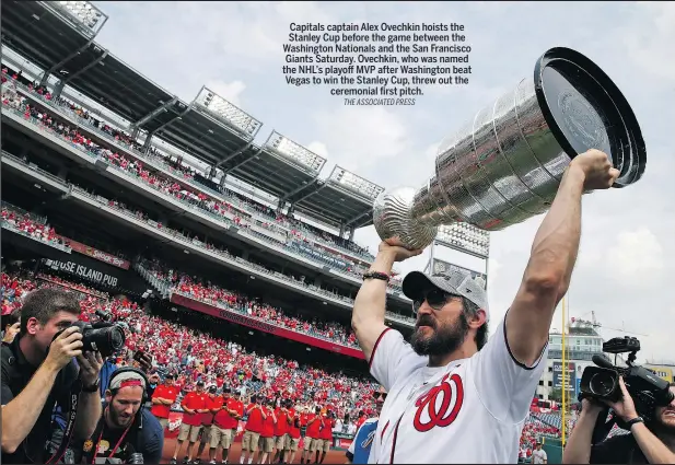  ?? THE ASSOCIATED PRESS ?? Capitals captain Alex Ovechkin hoists the Stanley Cup before the game between the Washington Nationals and the San Francisco Giants Saturday. Ovechkin, who was named the NHL’s playoff MVP after Washington beat Vegas to win the Stanley Cup, threw out...