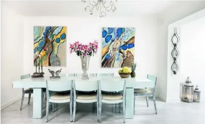  ??  ?? TOP LEFT: Darina Ni Chuinneaga­in-Donnelly enlivened her dining area by painting the large table in duck-egg blue. The paintings, which are by well-known Dutch artist Jean Nies, add terrific pops of colour