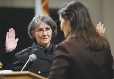  ?? Photos by Liz Hafalia / The Chronicle ?? Anne Kirkpatric­k takes the oath of office as Oakland’s new police chief from Mayor Libby Schaaf.