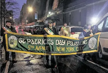  ?? Bridget O'Brien / Associated Press ?? Board members of the St. Patrick's Day Parade prepare to march in an impromptu parade Tuesday in New York. It was the first St. Patrick's Day in more than 250 years without a large parade in New York City.