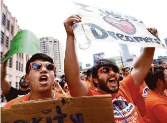  ?? Gary Coronado photos / Houston Chronicle ?? About 1,000 undocument­ed immigrant youth leaders, students and supporters rallied in front of the Harris County Sheriff’s Office on Saturday to protest deportatio­ns.