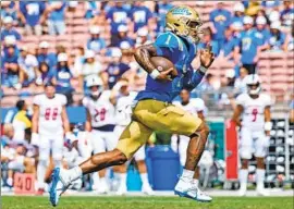  ?? Myung J. Chun Los Angeles Times ?? DORIAN THOMPSON-ROBINSON runs last Saturday at the Rose Bowl, where UCLA has averaged 30,072 fans in three games, which ranks 10th in the Pac-12.