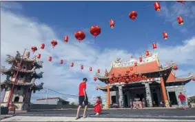  ??  ?? FAITH: People walk into a temple during the Chinese New Year celebratio­ns in Kuta, Bali, Indonesia.