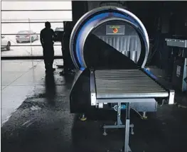  ??  ?? THE COMPANY’S latest 920 CT scanner creates a 3-D image of contents inside luggage. In April, OSI posted quarterly revenue of $304 million.