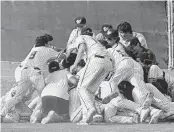  ?? ANDRE FERNANDEZ afernandez@miamiheral­d.com ?? Westminste­r Christian baseball players pile on each other after the final out of their victory over Fort Lauderdale Calvary Christian in the Region 4-3A final on Tuesday afternoon at Westminste­r Christian.