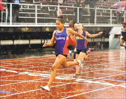  ?? Christian Abraham / Hearst Connecticu­t Media ?? Danbury’s Alanna Smith crosses the finish for first place in the 100-meter dash final during the CIAC Class LL championsh­ips on Wednesday in New Britain.