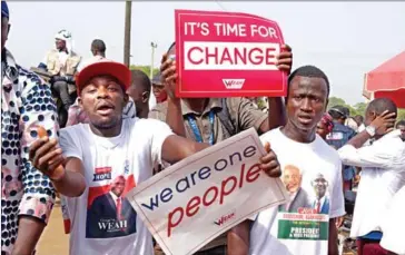  ?? SEYLLOU/AFP ?? Supporters of then-Liberian presidenti­al candidate and ex-football internatio­nal George Weah dance near his home in Monrovia on December 23.