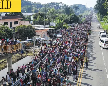  ?? PEDRO PARDO / AFP / GETTY IMAGES ?? Thousands of migrants march toward the U.S. on the road linking Ciudad Hidalgo and Tapachula, Mexico, on Sunday.