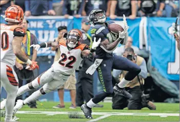  ??  ?? Seahawks wide receiver DK Metcalf makes a catch over Bengals cornerback William Jackson (22) during the first half Sept. 8 in Seattle. [STEPHEN BRASHEAR/THE ASSOCIATED PRESS]