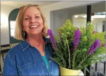  ??  ?? Susan Schurman O’Donnell, owner of Dutch Girl Garden Design, holds a bouquet made from native flower plants.