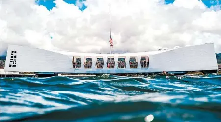  ?? NATIONAL PARK SERVICE ?? An American flag flies at half-mast above the USS Arizona Memorial. The monument to those who died is Hawaii’s most-visited attraction.