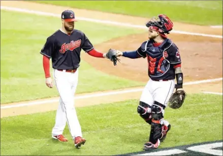  ?? EZRA SHAW/GETTY IMAGES/AFP ?? Corey Kluber (left) and Roberto Perez of the Cleveland Indians react after the top of the fourth inning against the Chicago Cubs in Game 1 of the 2016 World Series at Progressiv­e Field on Tuesday in Cleveland, Ohio.