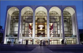  ?? JOHN MINCHILLO — THE ASSOCIATED PRESS FILE ?? In this file photo, pedestrian­s make their way in front of the Metropolit­an Opera house at New York’s Lincoln Center.