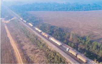  ?? THE ASSOCIATED PRESS ?? Trucks sit idle on highway BR-163, blocked by Kayapo Indigenous protesters near Novo Progresso, Para state, Brazil, on Monday. Protesters blocked the road to pressure Brazilian President Jair Bolsonaro to better shield them from COVID-19.