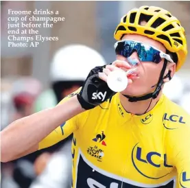  ??  ?? Froome drinks a cup of champagne just before the end at the Champs Elysees Photo: AP