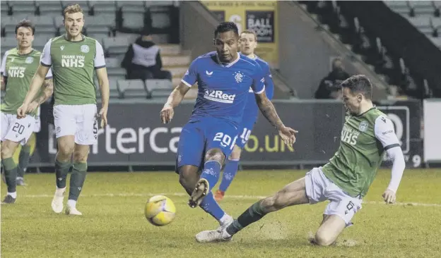  ??  ?? 0 Alfredo Morelos fires home the winning goal for Rangers at Easter Road last night after the referee missed his earlier stamp on Ryan Porteous.