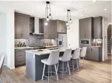  ??  ?? The spacious kitchen features stainless steel appliances.