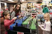  ?? SARAH A. MILLER AP ?? Young shoppers at a GameStop. The company will build a call center and operations hub in Pembroke Pines.