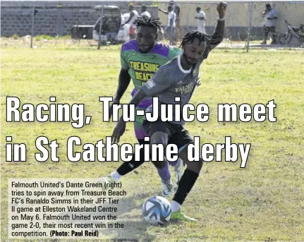  ?? (Photo: Paul Reid) ?? Falmouth United’s Dante Green (right) tries to spin away from Treasure Beach FC’S Ranaldo Simms in their JFF Tier II game at Elleston Wakeland Centre on May 6. Falmouth United won the game 2-0, their most recent win in the competitio­n.