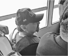  ??  ?? A picture handout by the Polizia di Stato shows Battisti sitting by Interpol police officers into a bus prior to boarding a plane chartered by the Italian government, in Santa Cruz de la Sierra, Bolivia. — AFP photo