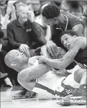  ?? David J. Phillip Associated Press ?? HOUSTON’S P.J. Tucker. left, battles Lou Williams, right, and Patrick Beverley for a loose ball.