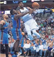  ?? JEROME MIRON / USA TODAY SPORTS ?? Dallas Mavericks forward Nerlens Noel is fouled by Oklahoma City Thunder guard Victor Oladipo during the first quarter.