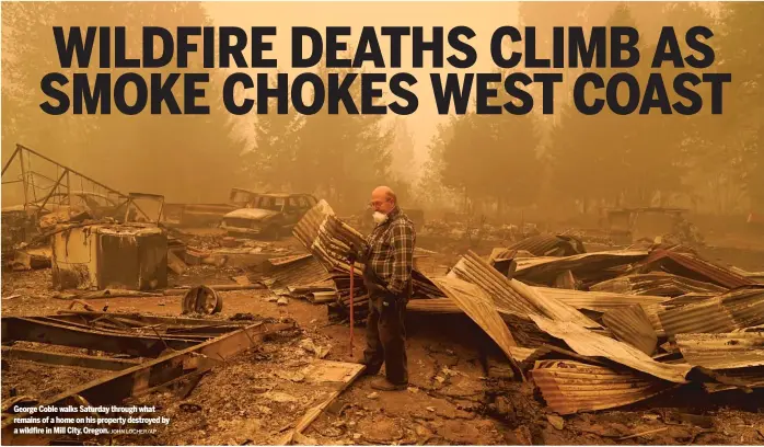  ?? JOHN LOCHER/AP ?? George Coble walks Saturday through what remains of a home on his property destroyed by a wildfire in Mill City, Oregon.