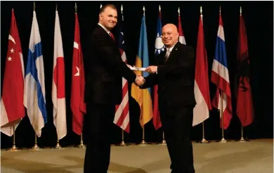  ?? (Courtesy photo) ?? Executive Assistant Director for the FBI's Intelligen­ce Branch Joshua Skule (left) hands Captain Mark Ballard of Starkville Police Department his certificat­e at the FBI National Academy graduation ceremony on July 7.