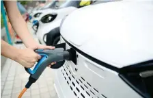  ?? — Reuters ?? An electric vehicle gets recharged at a station in Liuzhou, China.