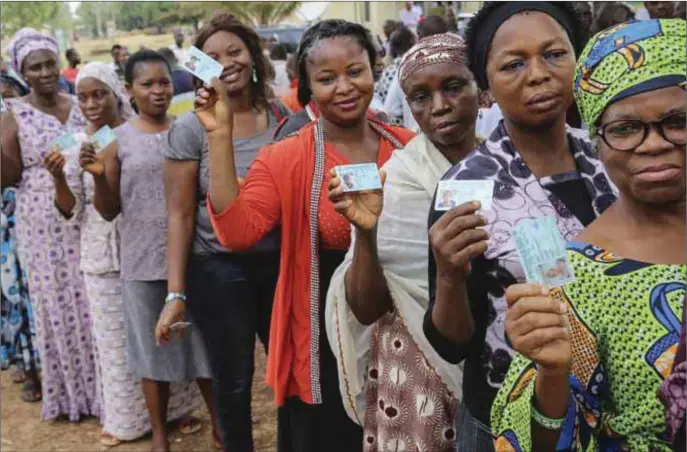  ??  ?? Some voters flash their voter cards. Are they doing this for money?