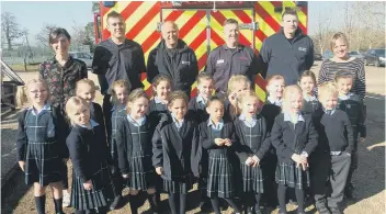  ?? CONTRIBUTE­D BY FARLINGTON ?? The firefighte­rs join staff and pupils at Farlington
