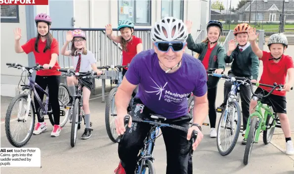  ??  ?? All set teacher Peter Cairns gets into the saddle watched by pupils