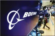  ?? ?? In this March 11, 2019 file photo, the Boeing logo appears above a trading post on the floor of the New York Stock Exchange. Saudi Arabia is buying up to 121 jetliners from Boeing in a big boost for the American manufactur­er. The deal was expected to be announced Tuesday, March 14, 2023. (AP)