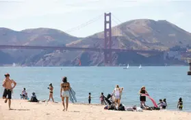  ?? Lea Suzuki / The Chronicle ?? Crissy Field beach attracts visitors Monday, when the city hit a high of 97.