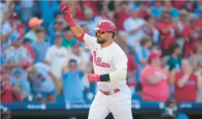  ?? MATT SLOCUM/AP ?? The Phillies’ Kyle Schwarber reacts after hitting a three-run home run against the Nationals during the fourth inning of the first game of Tuesday’s doublehead­er in Philadelph­ia.