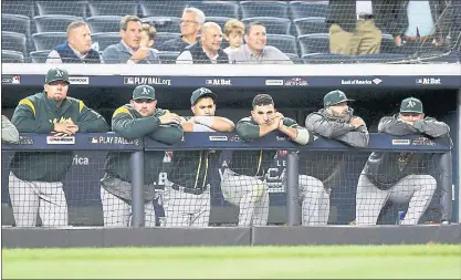  ?? PHOTOS BY JANE TYSKA — STAFF PHOTOGRAPH­ER ?? Oakland Athletics watch in despair from the dugout in the ninth inning of their wild-card game against the New York Yankees in New York on Wednesday. The Yankees won the game 7-2.