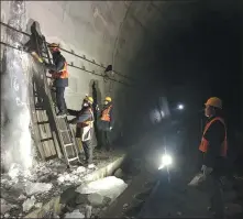  ?? SUN RUISHENG / CHINA DAILY ?? Members of the maintenanc­e squad clear ice on the wall of a tunnel along the Lyuliang section of the Taiyuan-Zhongwei-Yinchuan railway in Shanxi province.