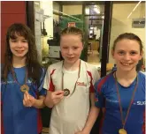  ??  ?? Alannah Cunningham, Jessica Greer and Aoibhin McGlinchey with their medals.