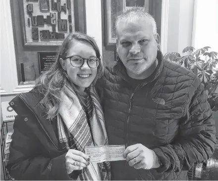  ?? Corey Leblanc ?? Madison Harpell of Indian Harbour Lake receives the inaugural Helping the Helpers scholarshi­p from John Garth Macdonald. Harpell is a freshman nursing student at Dalhousie University in Halifax.