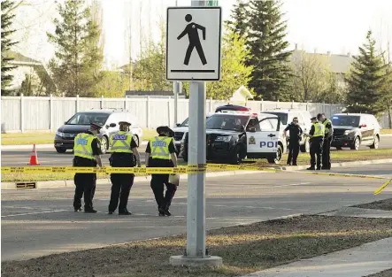  ?? DAVID BLOOM ?? Police work at the scene of a hit-and-run incident Tuesday at the 31 Street and 38 Avenue crosswalk. A 15-year-old girl was rushed to the hospital with serious head trauma.