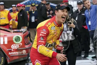  ?? MATT KELLEY — THE ASSOCIATED PRESS ?? Joey Logano reacts in Victory Lane after winning a NASCAR Cup Series auto race at Darlington Raceway on Sunday in Darlington, S.C.